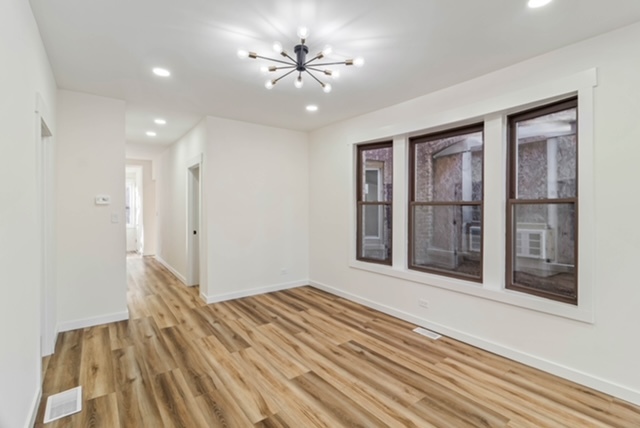 1018 North Harding Avenue Chicago, IL 60651 - Photo 4 of 38 a view of an empty room with a window