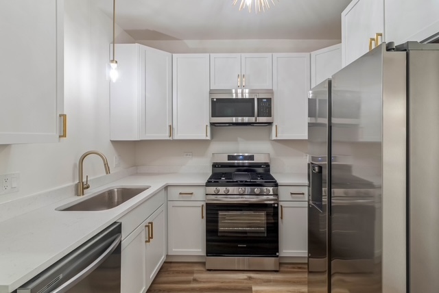 1018 North Harding Avenue Chicago, IL 60651 - Photo 8 of 38 a kitchen with stainless steel appliances and a sink