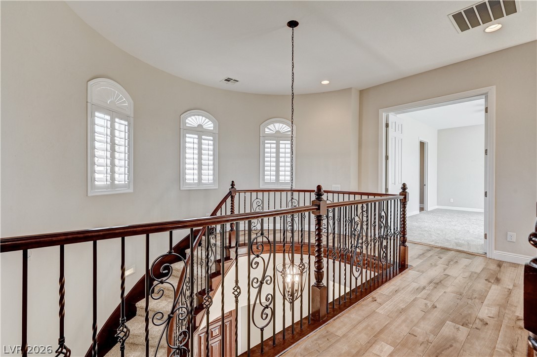 2793 Rosenhearty Drive Henderson, NV 89044 - Photo 34 of 77 Ornate wrought iron banisters and arched windows define this elegant upper landing.