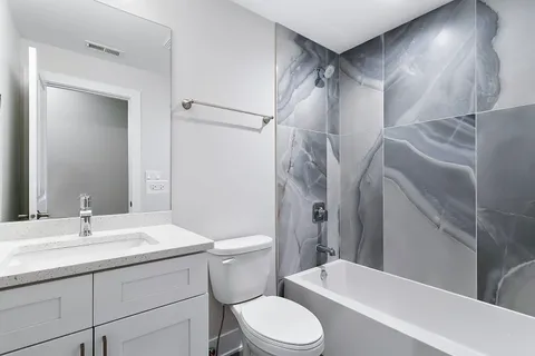 a bathroom with a sink toilet and shower
