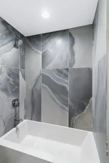 a bathroom with a bathtub and a shower