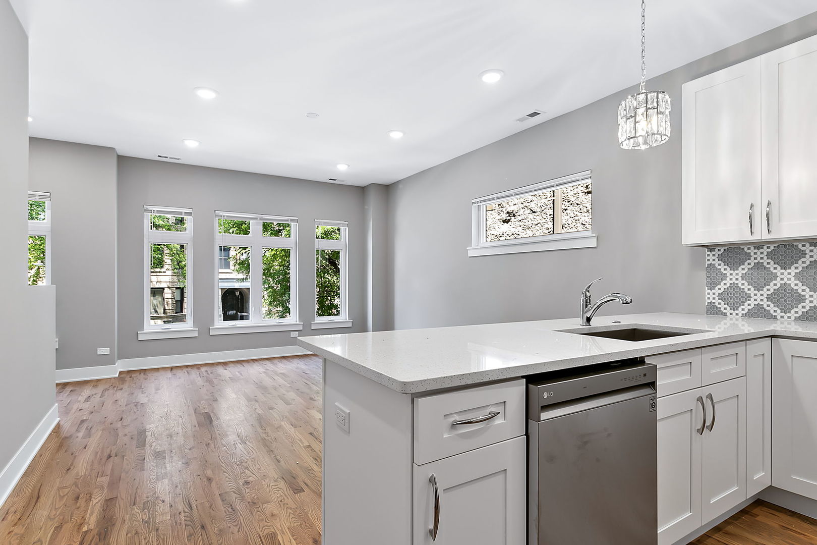 4231 South Champlain Avenue Chicago, IL 60653 - Photo 5 of 18 a kitchen with a sink window and cabinets