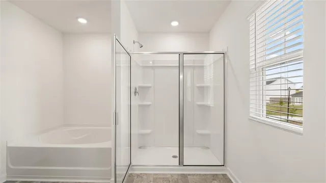 a bathroom with a glass shower door