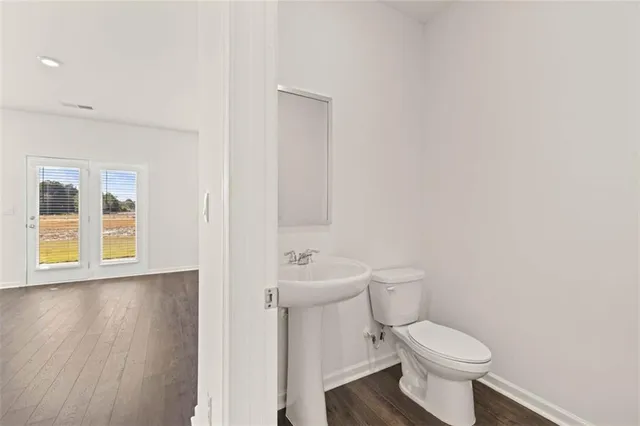 a bathroom with a toilet a sink and a window