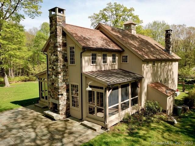 a view of house with a yard and wooden fence