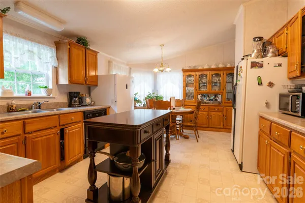 a kitchen with a table chairs sink and cabinets