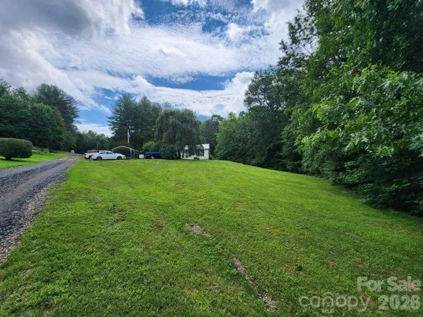 a view of a field of grass and trees