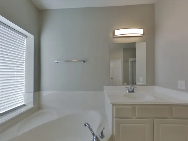 a bathroom with a bathtub and a sink