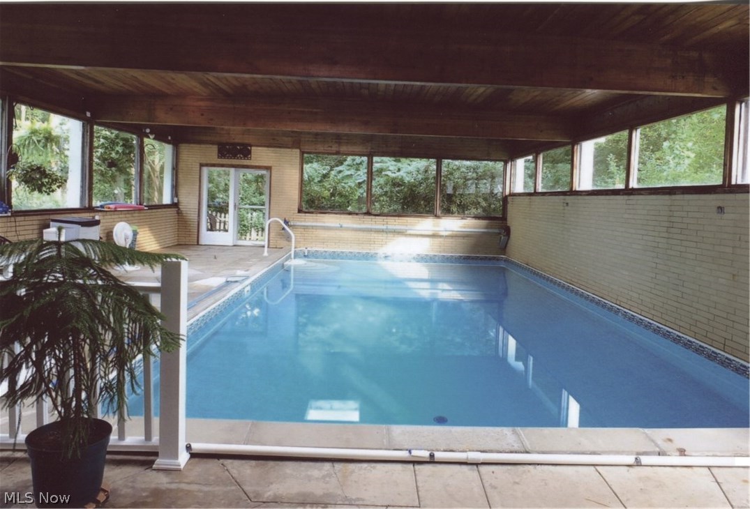 419 Mowbray Road Akron, OH 44333 - Photo 23 of 35 Indoor pool is bright with tranquil views of the surrounding trees.