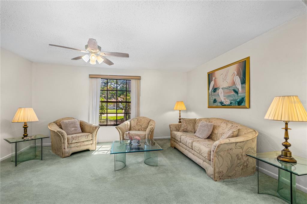 693 Reillys Road Port Orange, FL 32127 - Photo 10 of 31 a living room with furniture a couch and a chandelier
