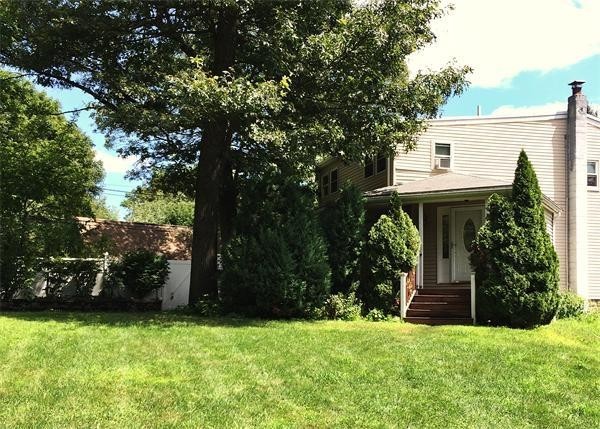14 Magnolia Road Natick, MA 01760 - Photo 1 of 11 a front view of a house with garden