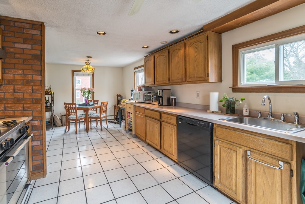 14 Magnolia Road Natick, MA 01760 - Photo 5 of 11 a kitchen with a sink appliances and cabinets
