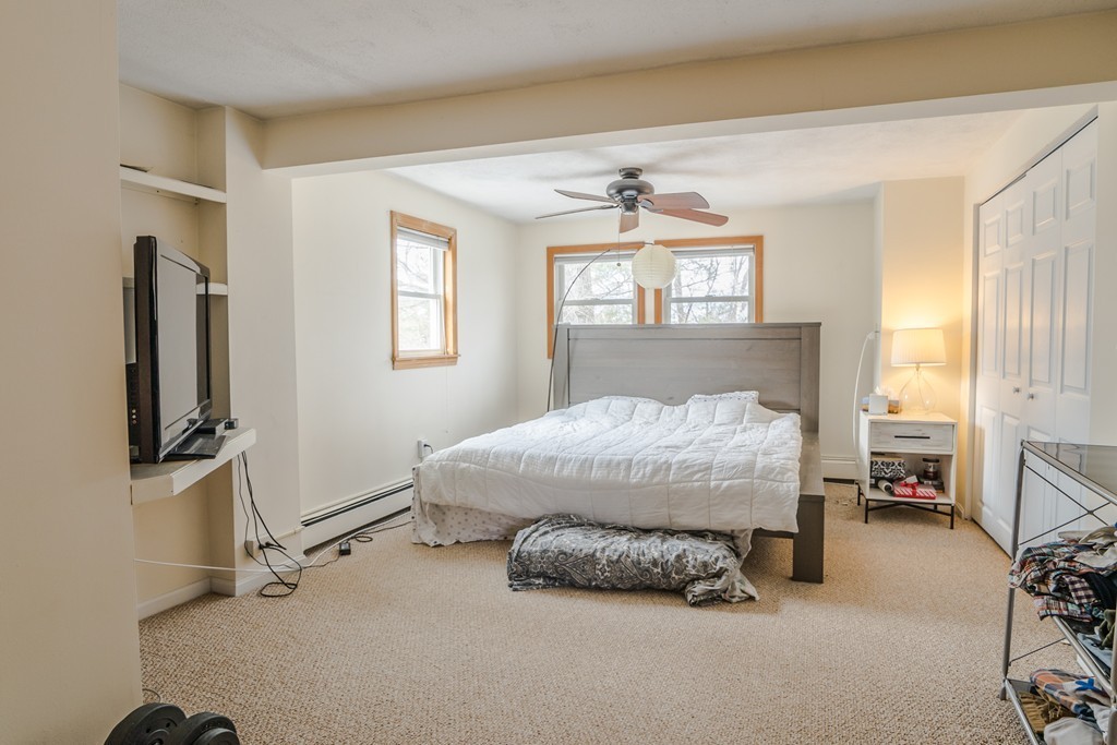 14 Magnolia Road Natick, MA 01760 - Photo 9 of 11 a bed room with a bed furniture and a flat tv screen
