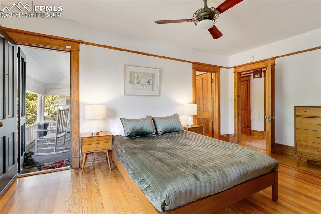 1331 North Tejon Street Colorado Springs, CO 80903 - Photo 23 of 45 a bedroom with a large bed and a chandelier