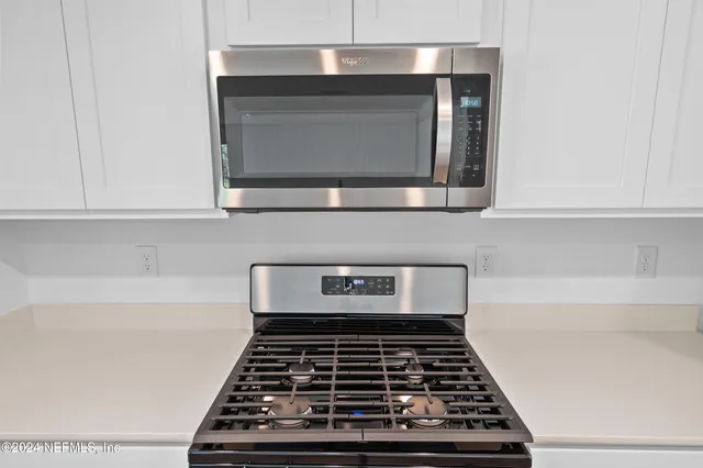 a kitchen with a stove and a microwave