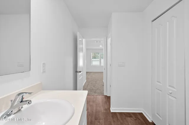 a bathroom with a sink and a mirror