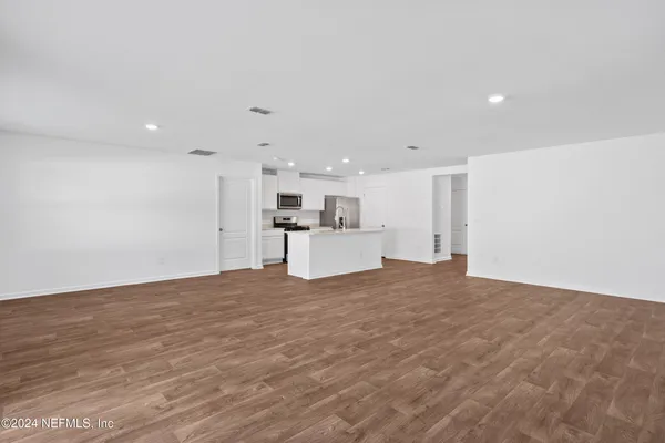 a view of a kitchen with a sink and a refrigerator