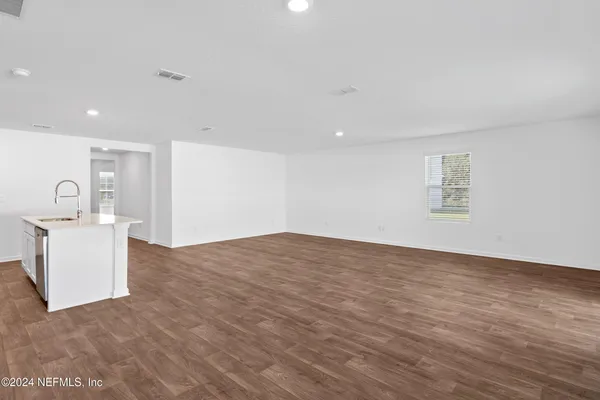 a view of a bedroom with a sink and a bed