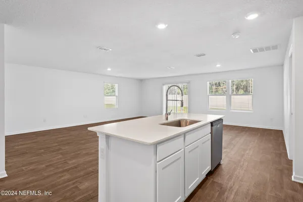 a view of a kitchen counter space and a sink