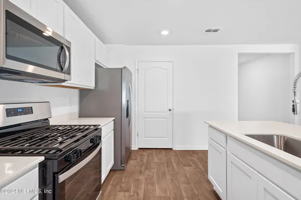 a kitchen with a stove and a microwave
