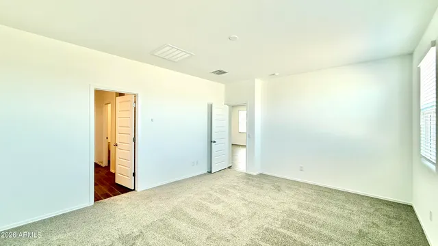 a view of a big room with closet and wooden door