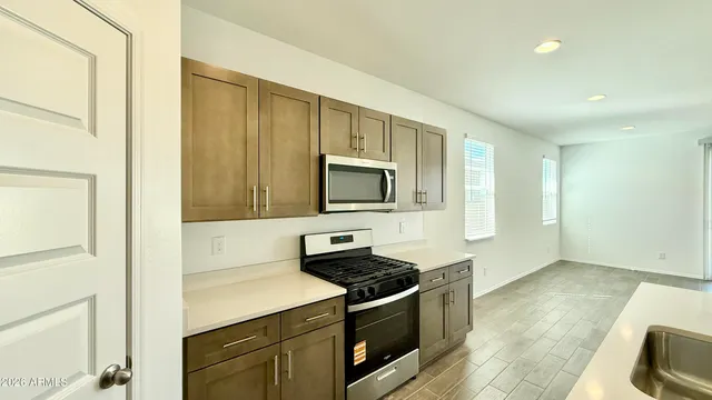 a kitchen with stainless steel appliances granite countertop a stove and a microwave