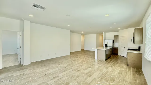 a view of a kitchen with a refrigerator and a sink