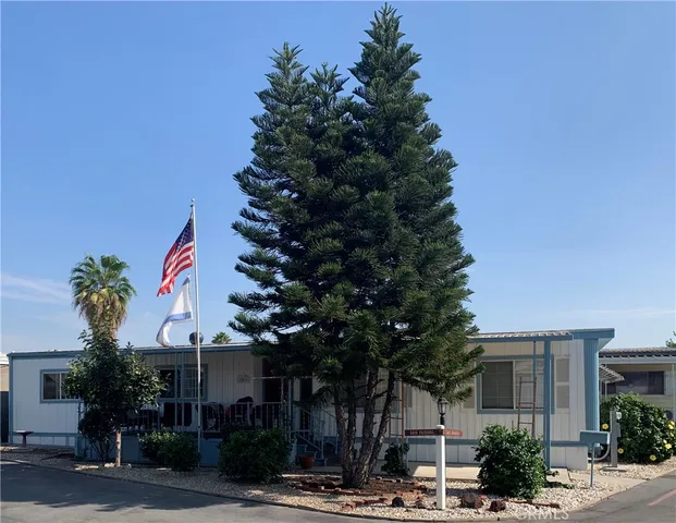 a front view of a multi story residential apartment building with trees
