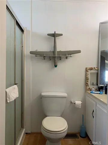 a white toilet sitting next to a bathroom sink