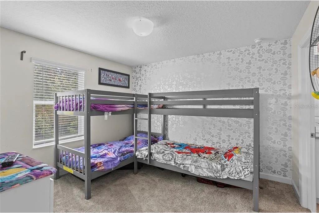 4585 Target Boulevard Kissimmee, FL 34746 - Photo 11 of 24 a bedroom with a bed and a window