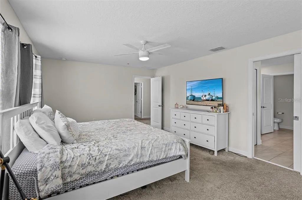 4585 Target Boulevard Kissimmee, FL 34746 - Photo 13 of 24 a bedroom with a bed and a flat screen tv
