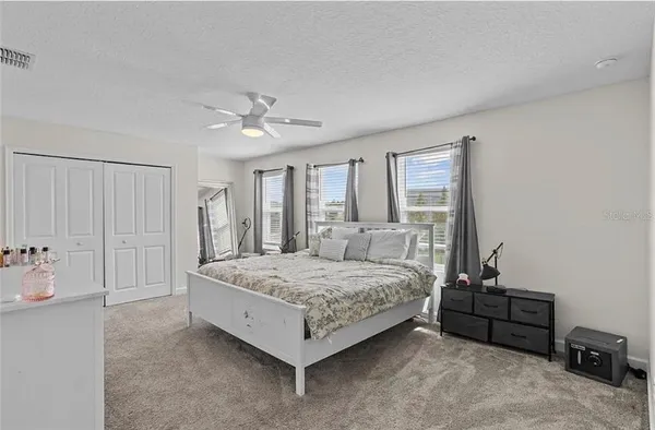 a bedroom with a bed a table and chair