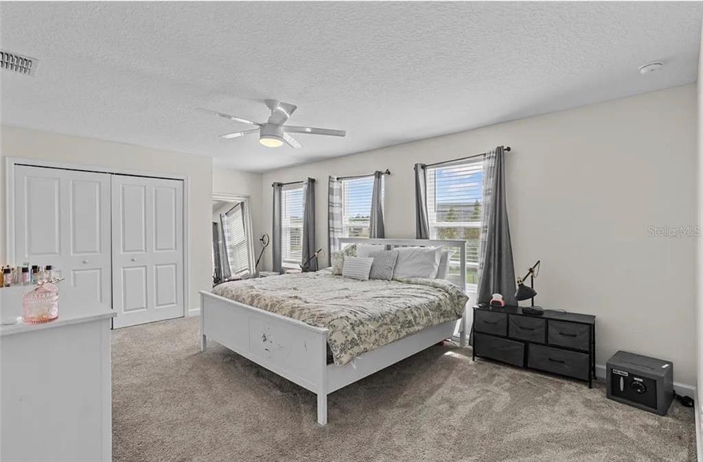 4585 Target Boulevard Kissimmee, FL 34746 - Photo 14 of 24 a bedroom with a bed a table and chair