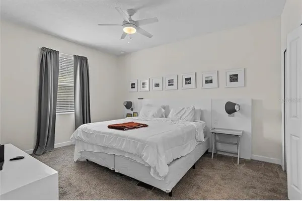 a bedroom with a bed and a chandelier