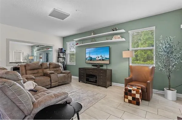 a living room with furniture a flat screen tv and a fireplace