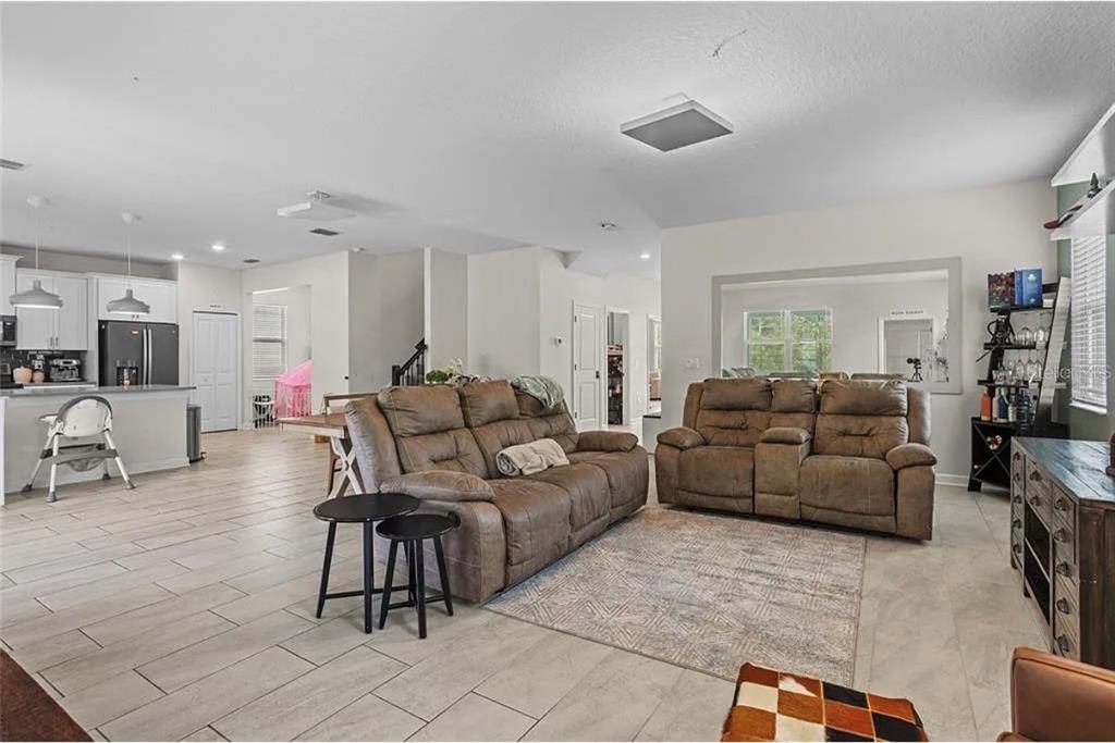 4585 Target Boulevard Kissimmee, FL 34746 - Photo 7 of 24 a living room with furniture and a flat screen tv