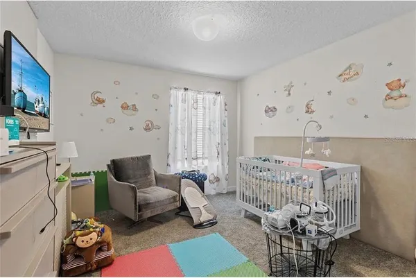 a bedroom with furniture and a rug