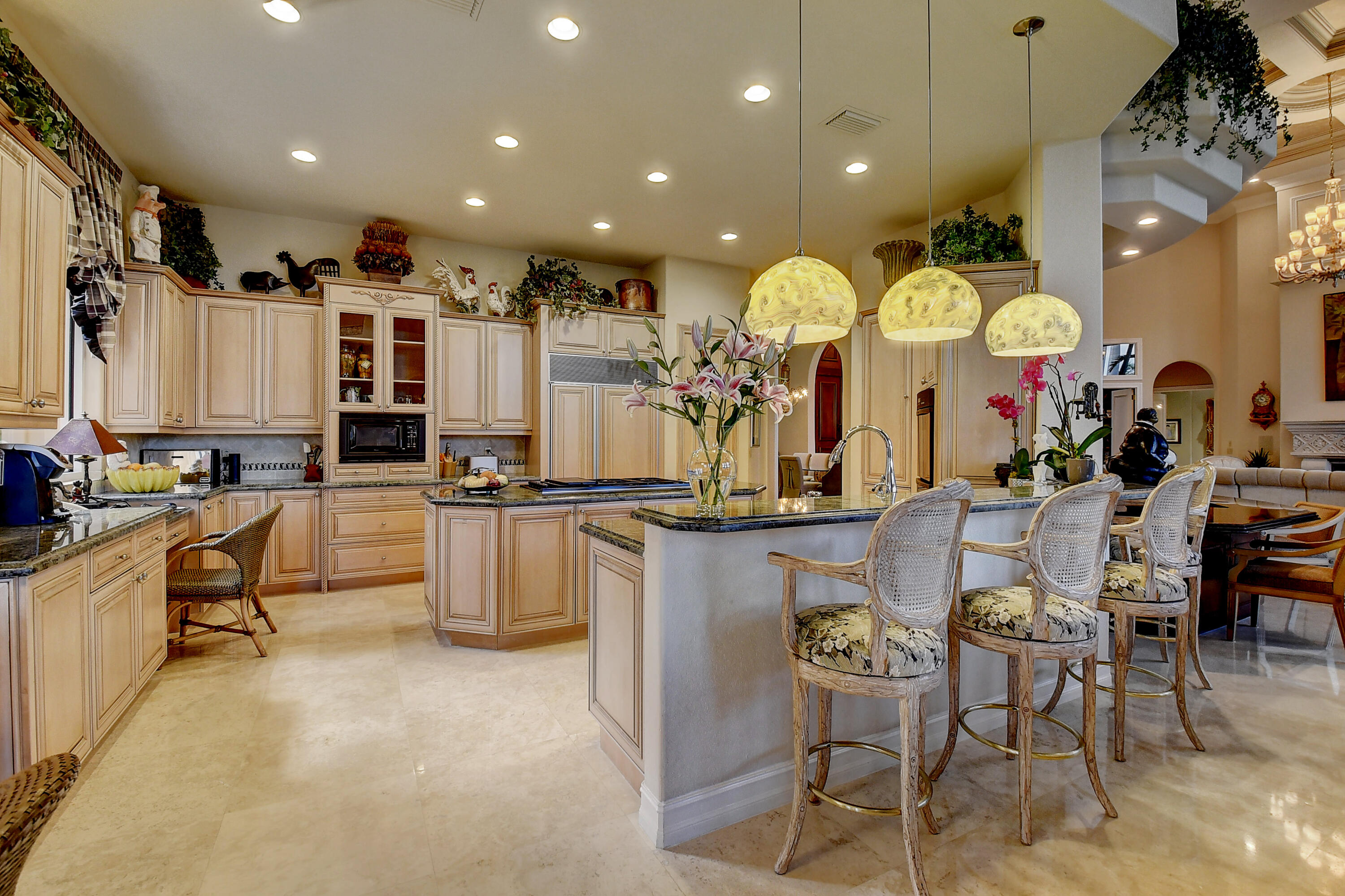 3811 Northwest Coventry Lane Boca Raton, FL 33496 - Photo 12 of 52 a large kitchen with lots of counter space and windows