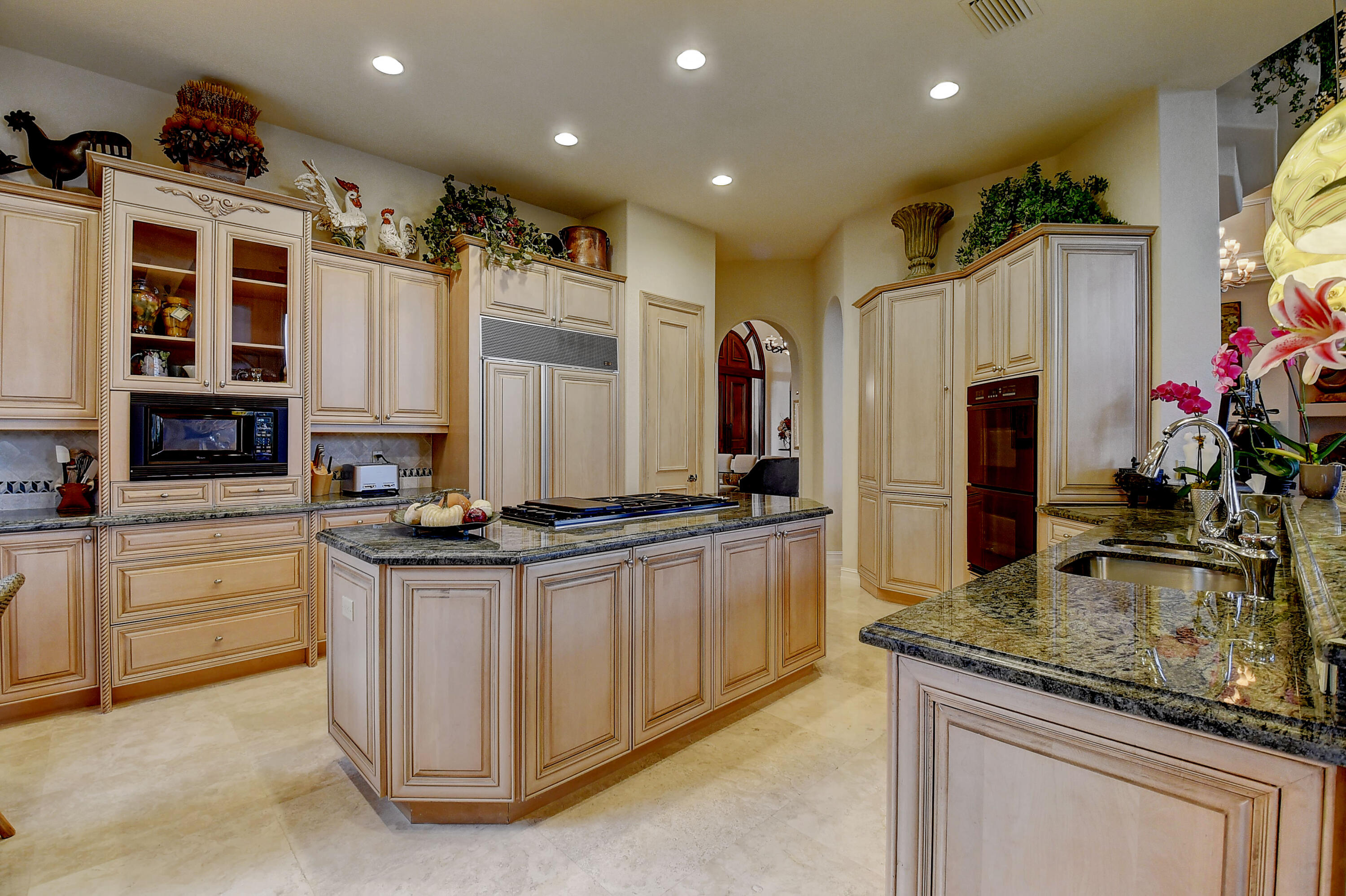 3811 Northwest Coventry Lane Boca Raton, FL 33496 - Photo 13 of 52 a kitchen with stainless steel appliances granite countertop a sink and a refrigerator