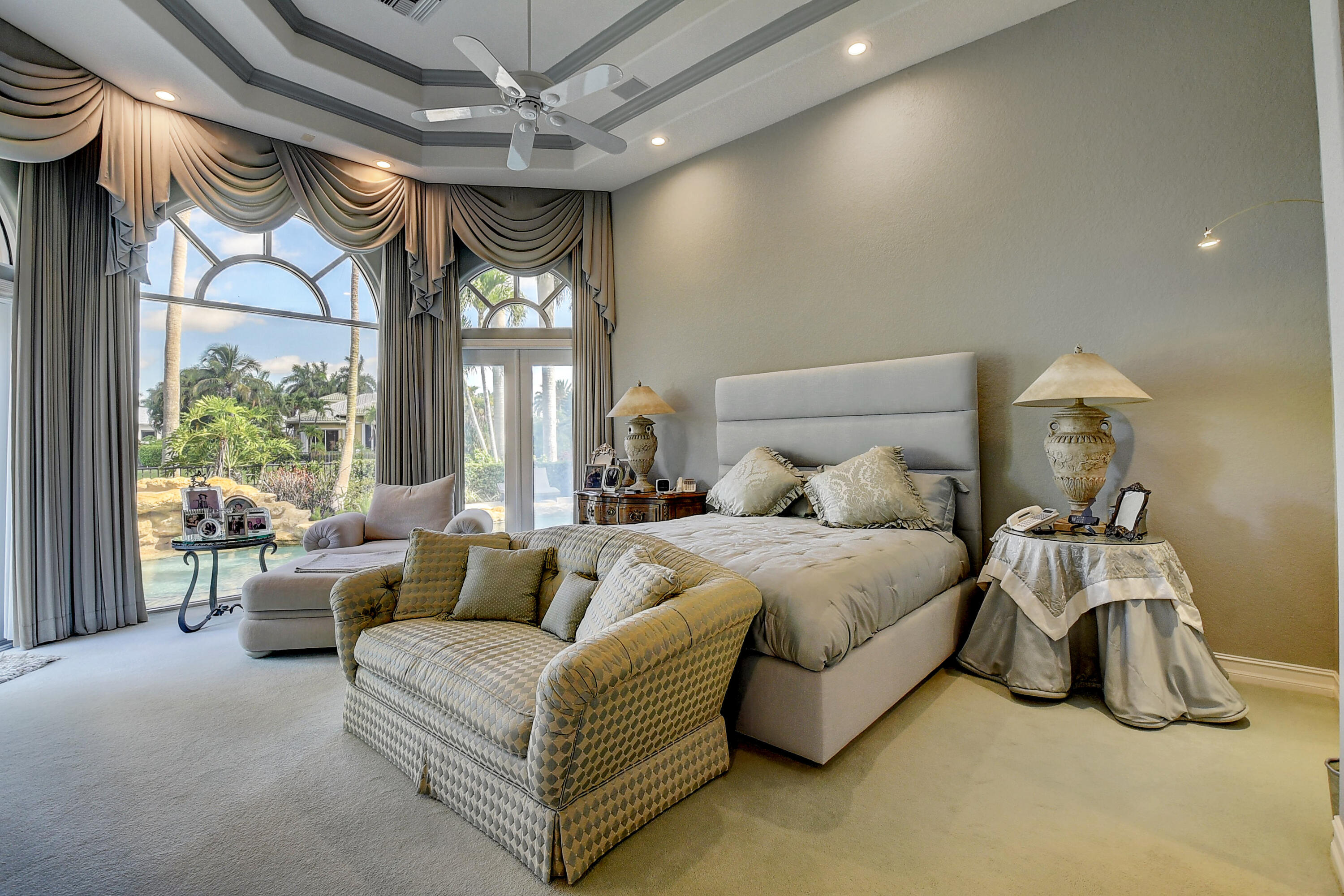 3811 Northwest Coventry Lane Boca Raton, FL 33496 - Photo 16 of 52 a spacious bedroom with a bed and a large window