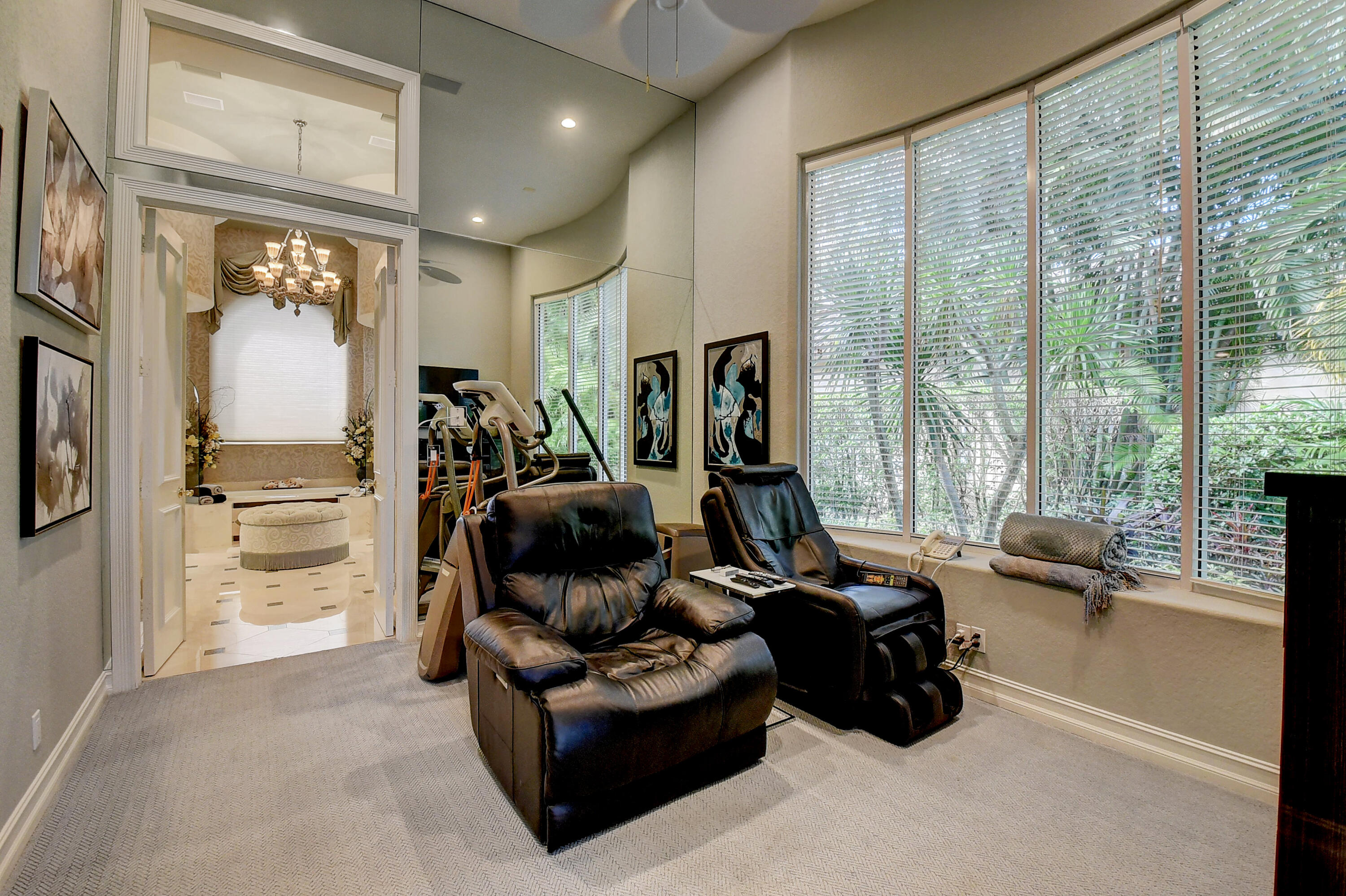 3811 Northwest Coventry Lane Boca Raton, FL 33496 - Photo 17 of 52 a room with furniture a floor to ceiling window and a flat screen tv