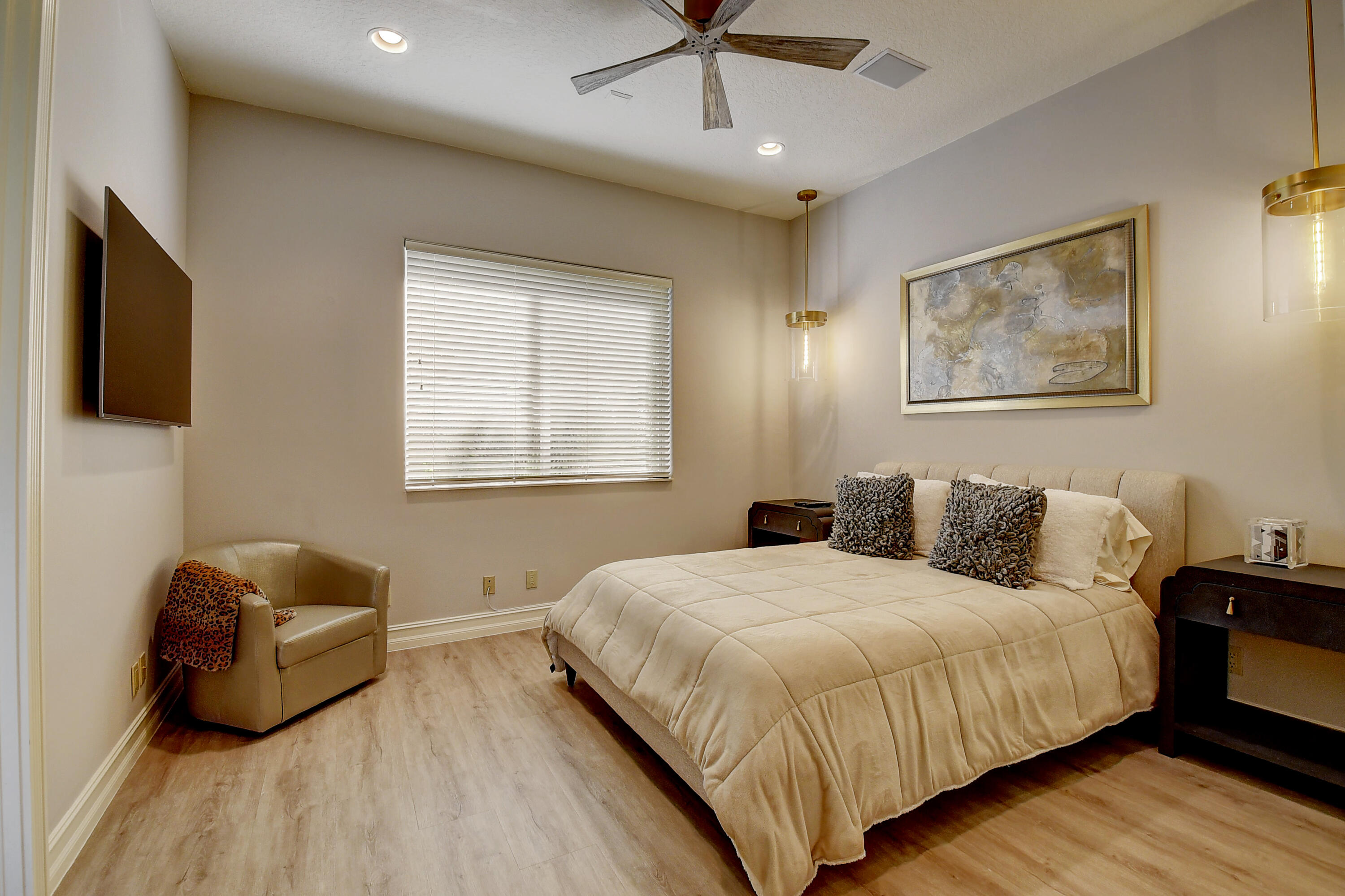 3811 Northwest Coventry Lane Boca Raton, FL 33496 - Photo 23 of 52 a bedroom with a bed and wooden floor