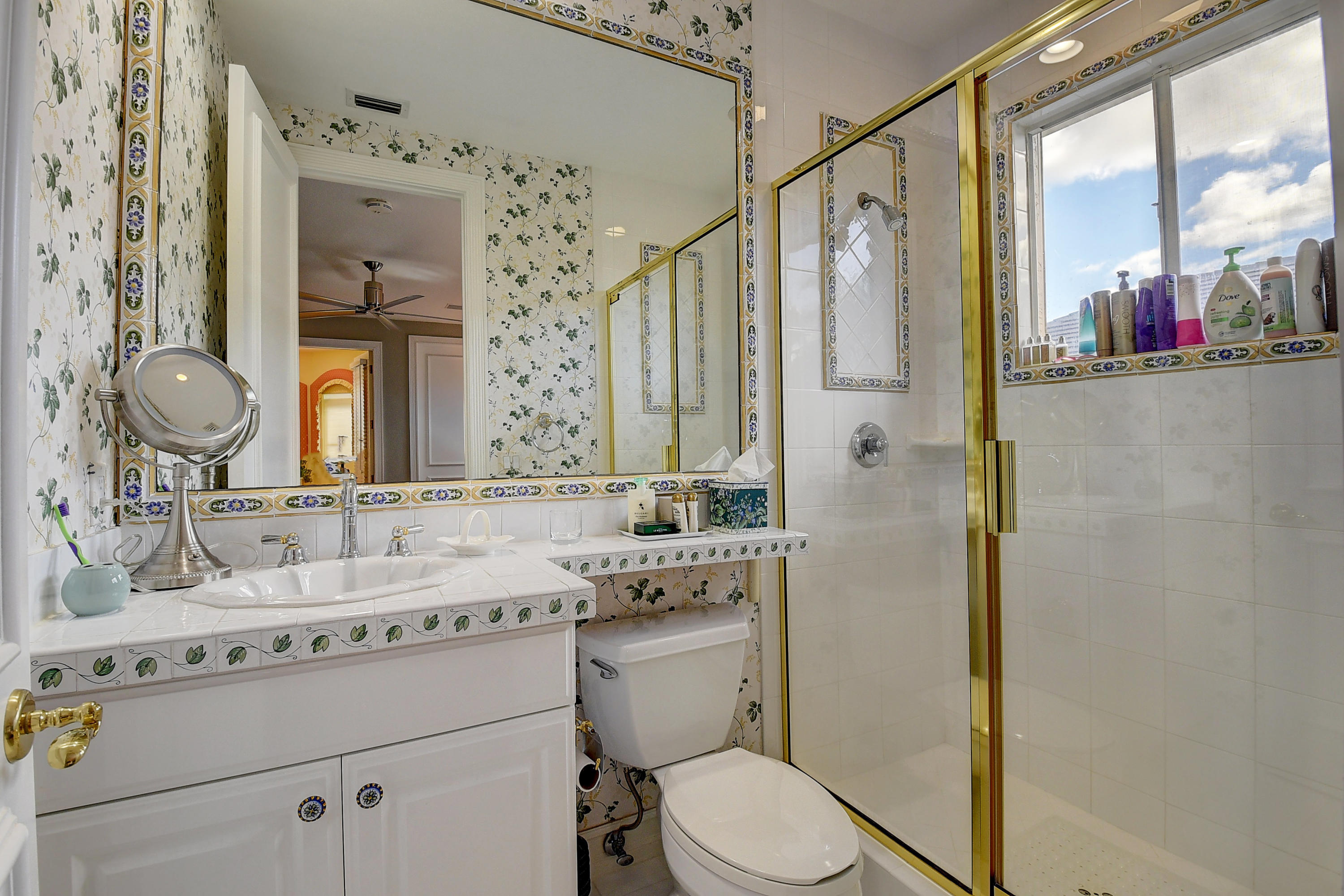 3811 Northwest Coventry Lane Boca Raton, FL 33496 - Photo 27 of 52 a bathroom with a granite countertop sink mirror vanity and toilet