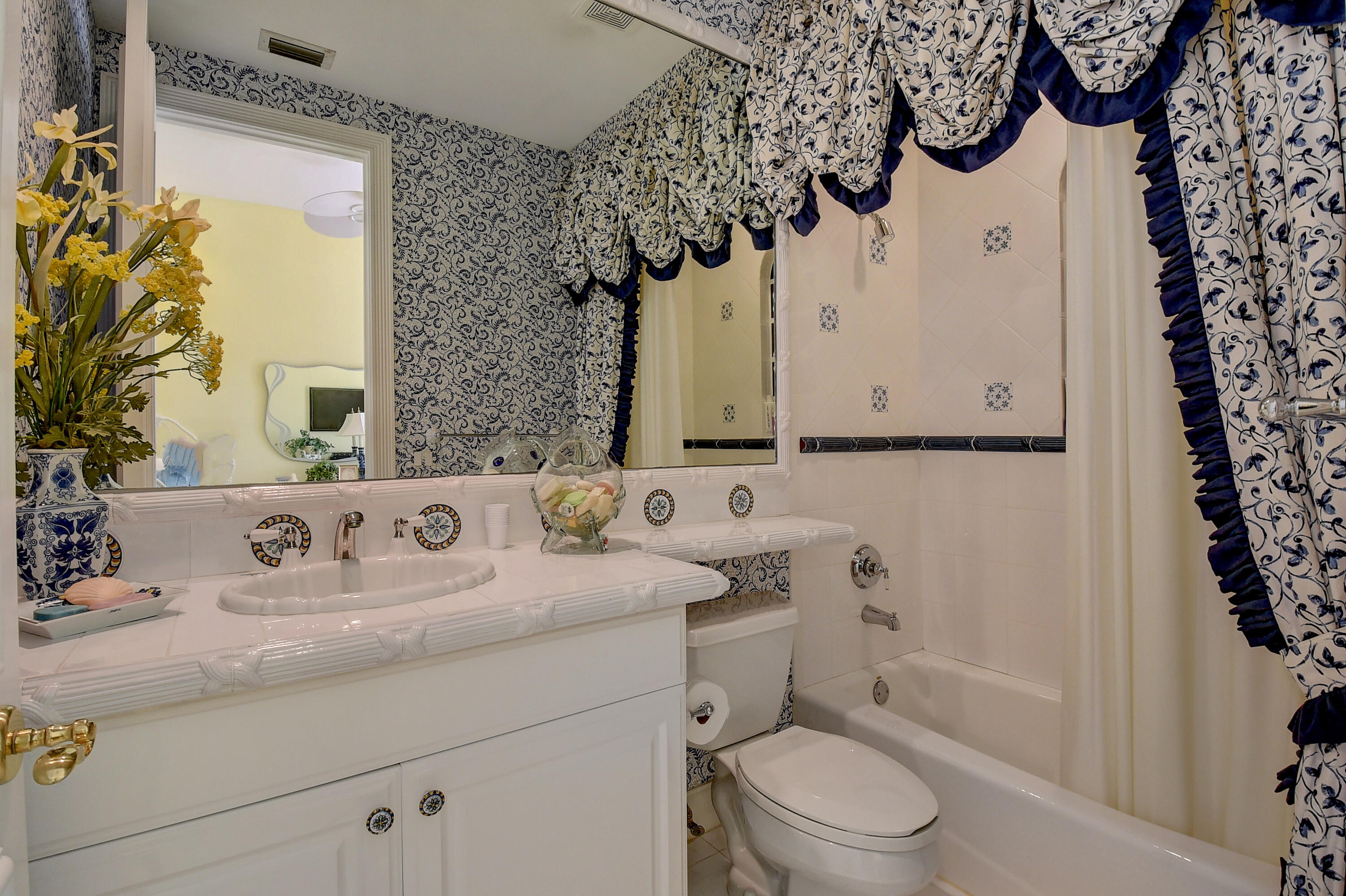 3811 Northwest Coventry Lane Boca Raton, FL 33496 - Photo 30 of 52 a bathroom with a sink a toilet and a mirror