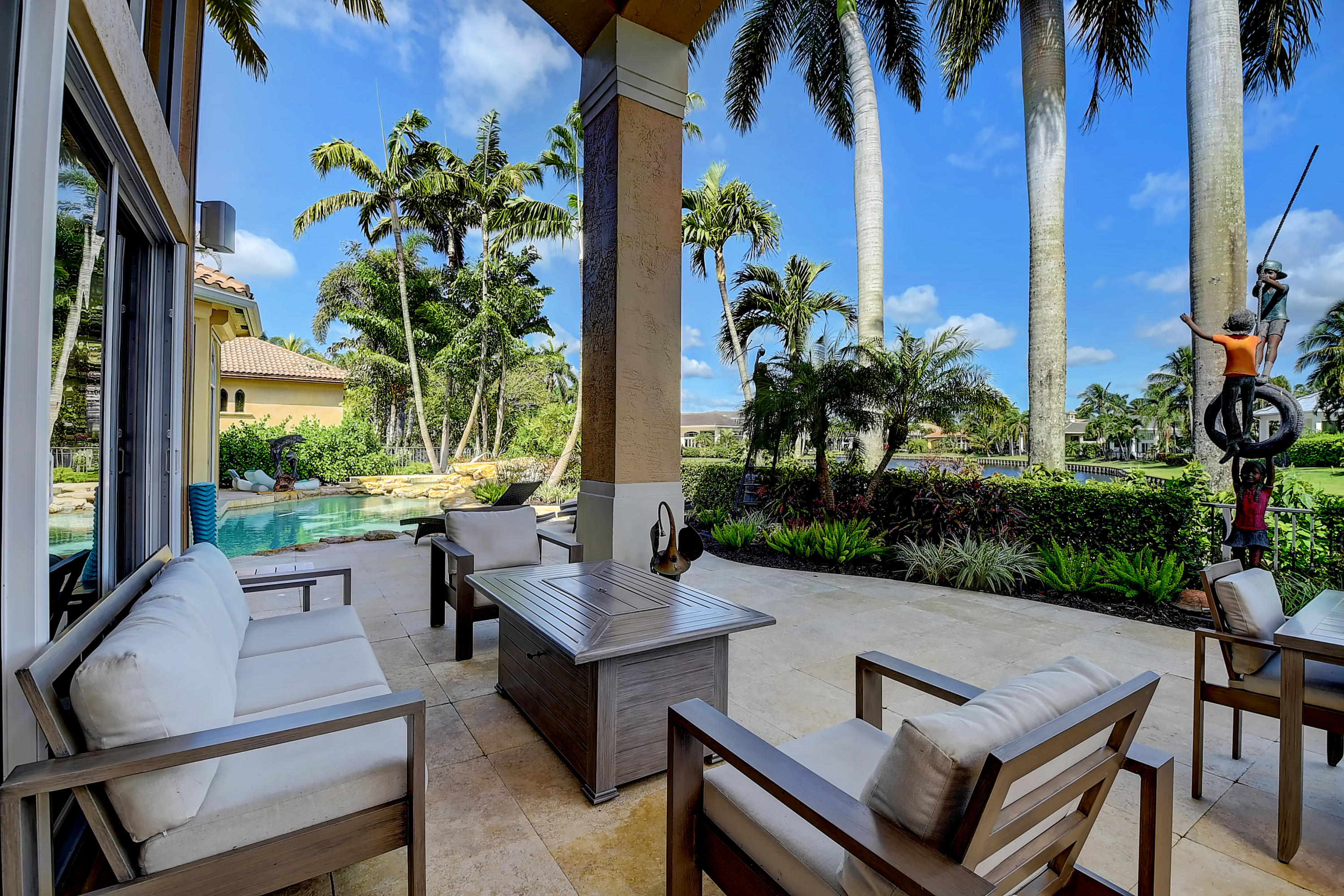 3811 Northwest Coventry Lane Boca Raton, FL 33496 - Photo 35 of 52 a view of a patio with plants and a table and chairs