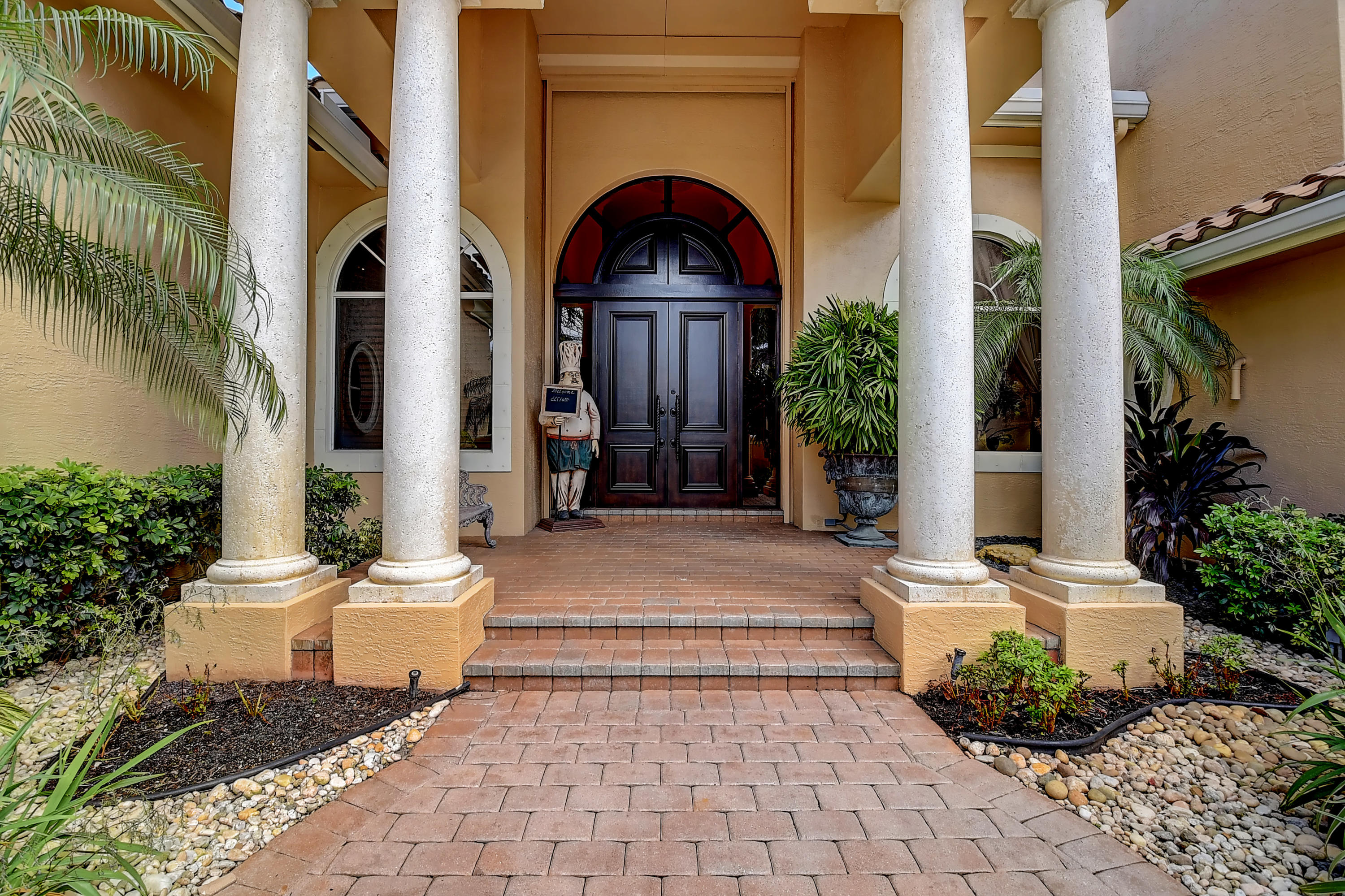 3811 Northwest Coventry Lane Boca Raton, FL 33496 - Photo 4 of 52 a front view of a house with garden