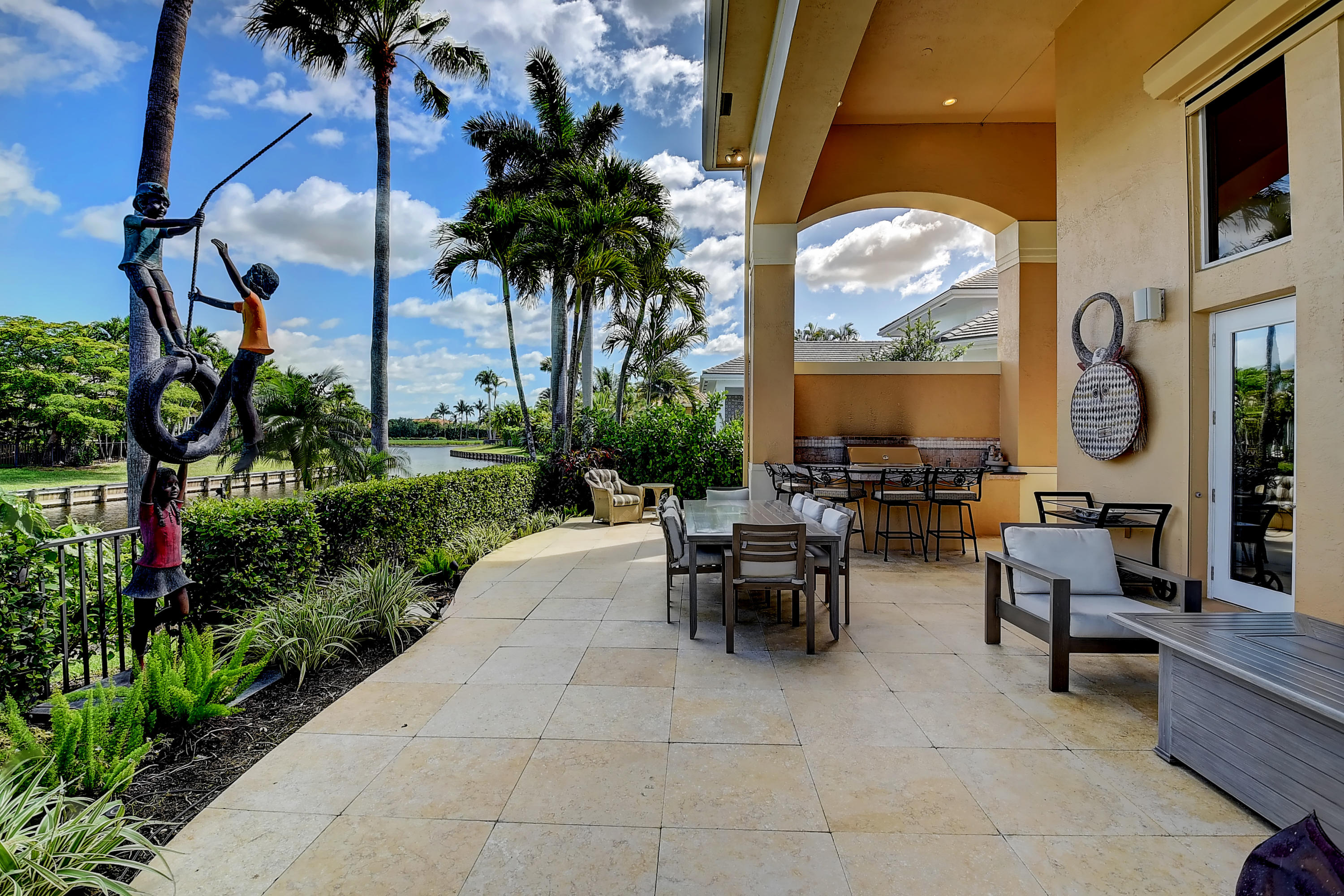 3811 Northwest Coventry Lane Boca Raton, FL 33496 - Photo 45 of 52 a view of a patio with couches and potted plants