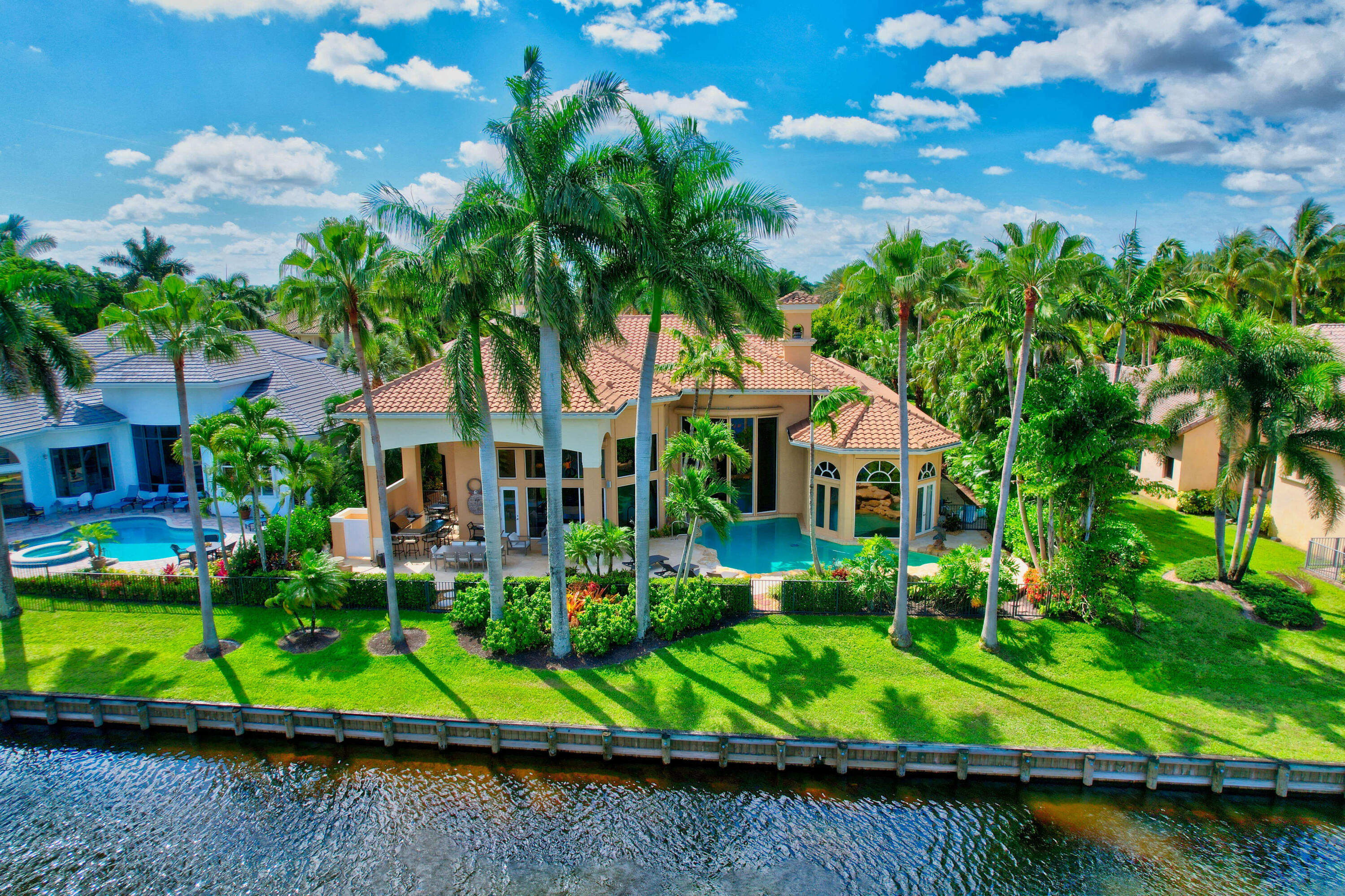 3811 Northwest Coventry Lane Boca Raton, FL 33496 - Photo 50 of 52 a view of house with swimming pool outdoor seating and lake