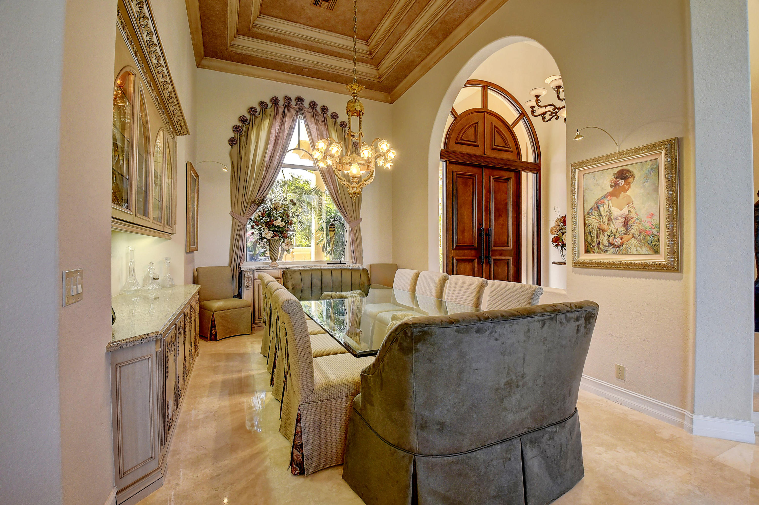 3811 Northwest Coventry Lane Boca Raton, FL 33496 - Photo 7 of 52 a living room with couches a fireplace and a dining table with garden view