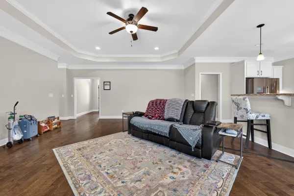 a living room with furniture and wooden floor